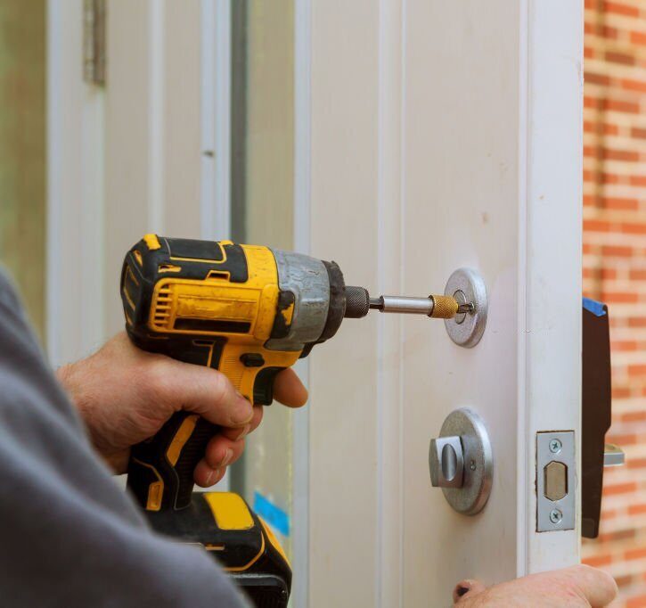 workers hands installing new door locker man repairing the doorknob closeup